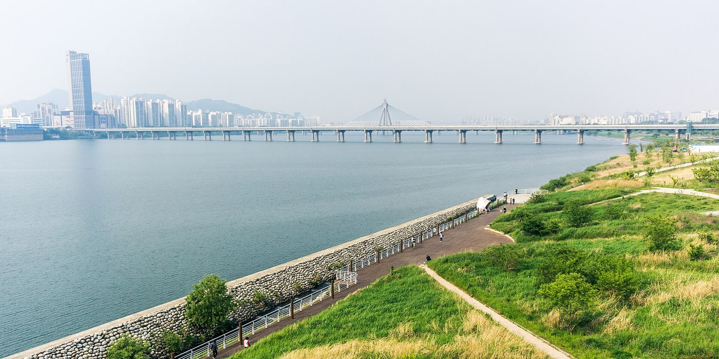 Families walk through a park in Seoul on Saturday. South Korea recorded about 262,000 births in the 12 months through August.
