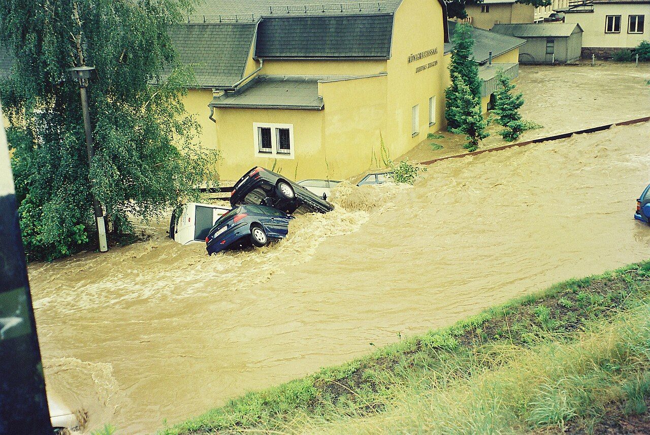 A flooded street after heavy rain. Insured losses from floods and hail in Europe reached about 14 billion euros this summer.