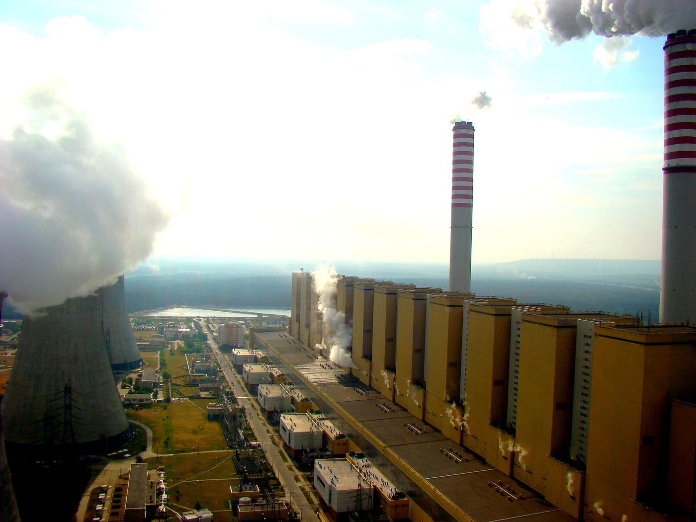 Cooling towers and smokestacks of the Bełchatów power station in central Poland, the largest coal-fired plant in Europe.
