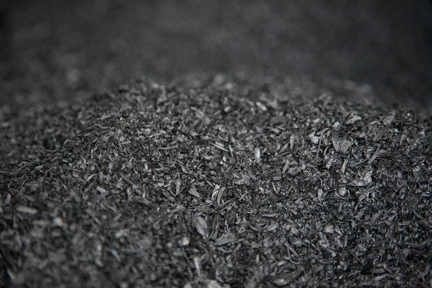 Biochar, a charcoal made by heating plant waste without oxygen, is spread on farmland to lock away carbon.