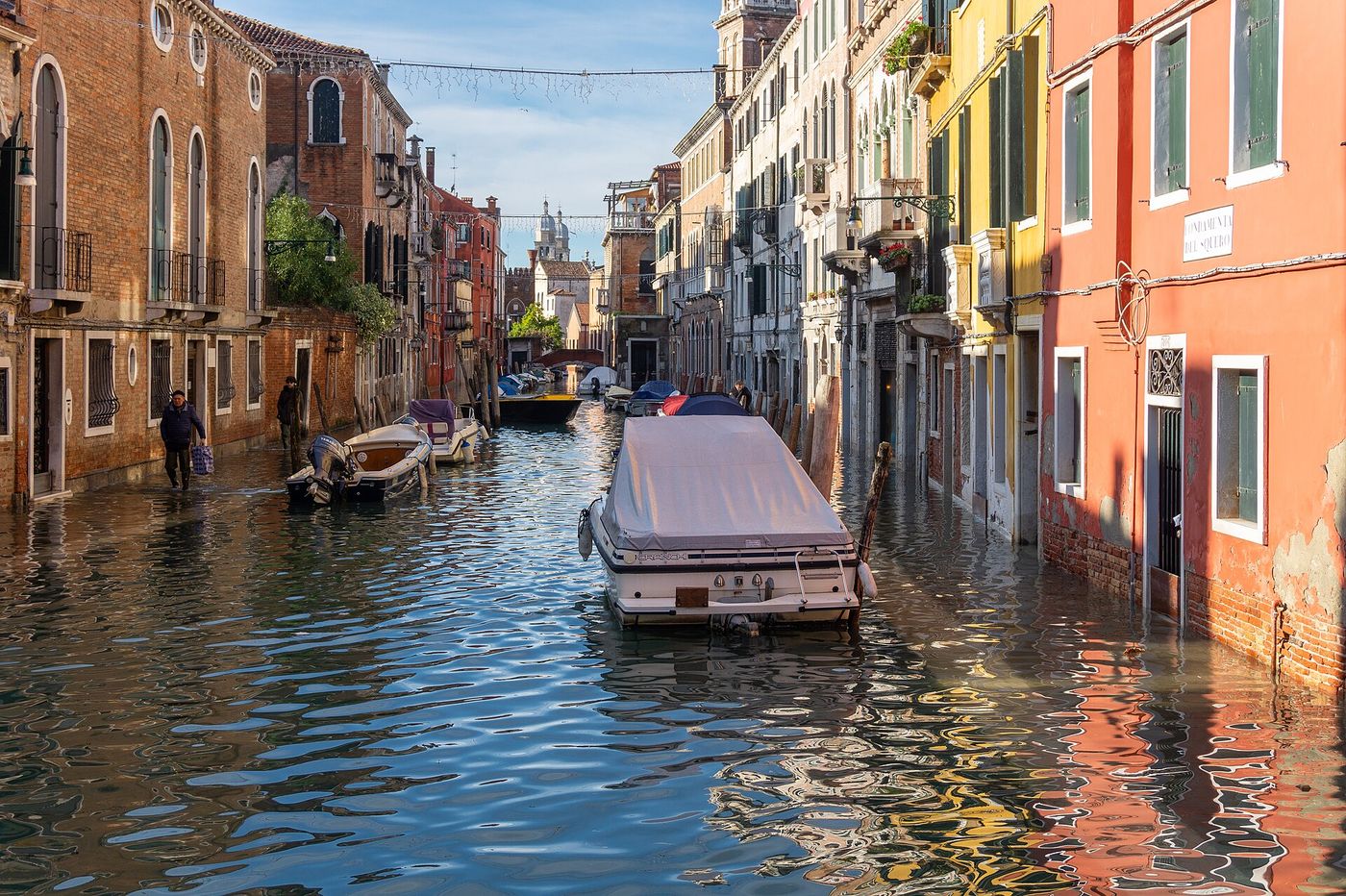 Tourists walk on raised platforms in St. Mark’s Square during a high tide in Venice.