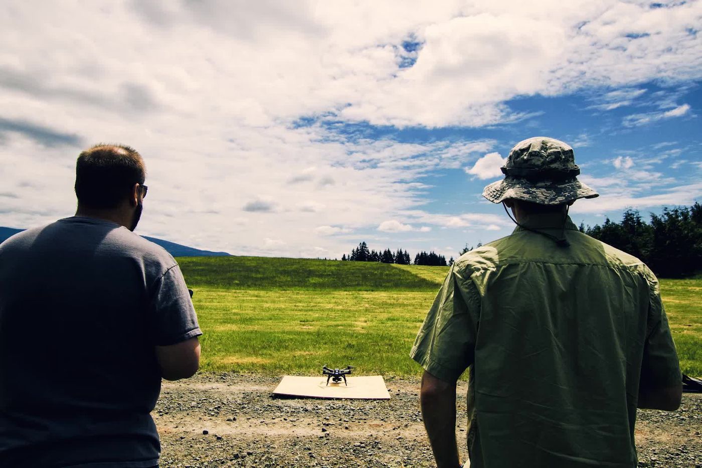 Operators practice flying a small quadcopter during a training session.